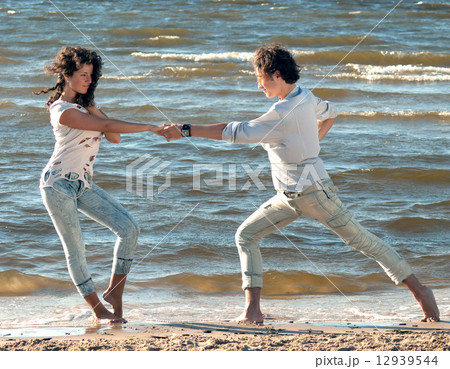 young couple dancing on a background of sea 12939544