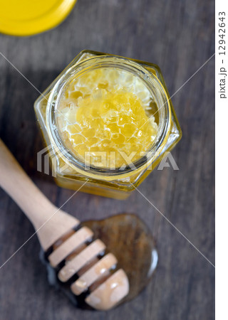 honeycomb and honey in glass jars 12942643