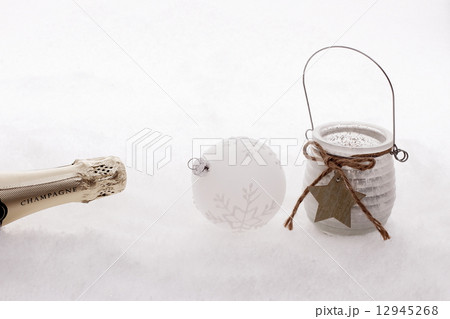 Christmas ball, wind candle, champagne bottle in snow Christmas ball, wind candle, champagne bottle in snow 12945268