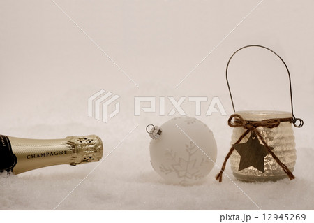 Christmas ball, wind candle, champagne bottle in snow Christmas ball, wind candle, champagne bottle in snow 12945269