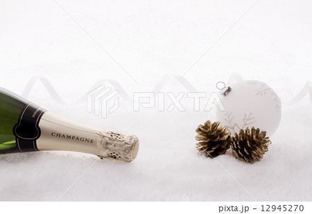 Champagne bottle in snow with christmas tree ball 12945270