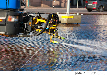 City street cleaning with strong water jets City street cleaning with strong water jets 12945350