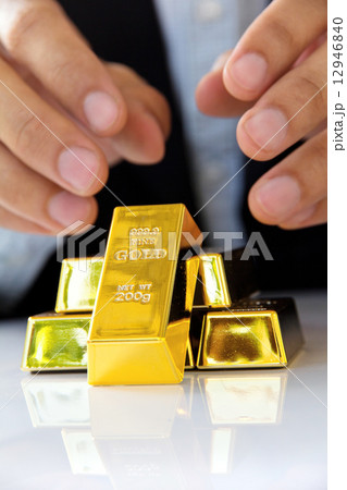 Hand hold gold bars 12946840