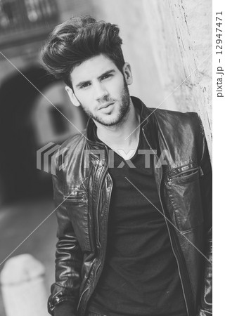 Attractive young handsome man, model of fashion in urban backgro Attractive young handsome man, model of fashion in urban backgro 12947471