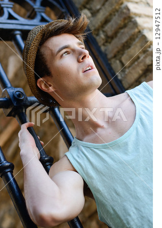 Attractive young handsome man, model of fashion in urban backgro Attractive young handsome man, model of fashion in urban backgro 12947512