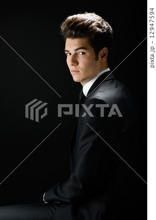 Young businessman, isolated on black background Young businessman, isolated on black background 12947594