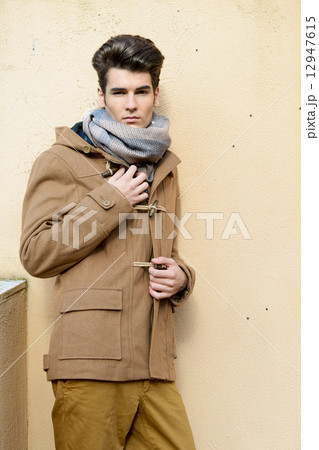 Attractive young handsome man, model of fashion in urban backgro 12947615