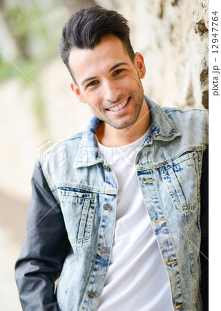 Attractive young handsome man, model of fashion in urban backgro 12947764
