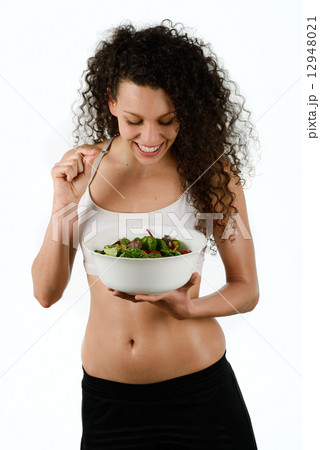Beautiful young mixed woman with salad, isolated on white 12948021