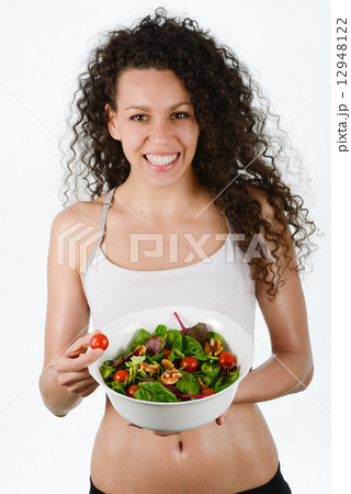 Beautiful young mixed woman with salad, isolated on white 12948122