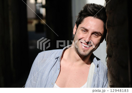 Portrait of young smiling man in urban background 12948183