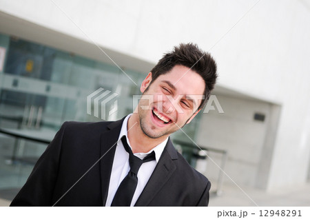 Portrait of a handsome young businessman laughing Portrait of a handsome young businessman laughing 12948291