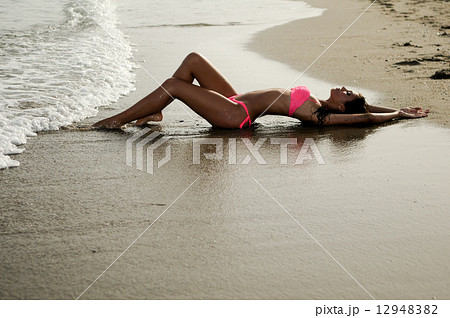 Woman with beautiful body on a tropical beach 12948382