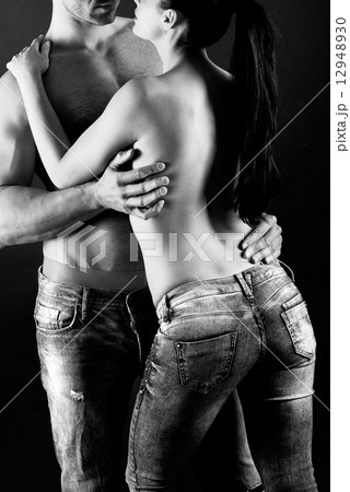 Sexy young couple with blue jeans standing together Sexy young couple with blue jeans standing together 12948930