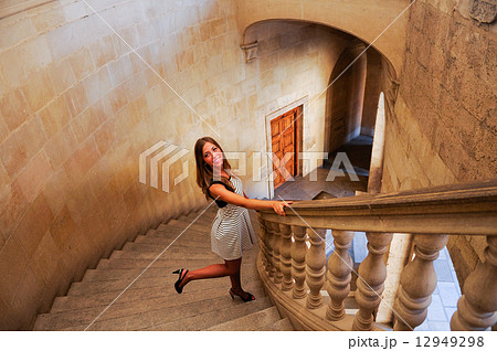 Attractive smiling blonde woman on stairs Attractive smiling blonde woman on stairs 12949298