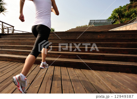 healthy lifestyle sports woman running on wooden stairs 12949387