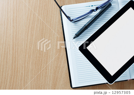 Modern tablet PC next to a classical open agenda Modern tablet PC next to a classical open agenda 12957305