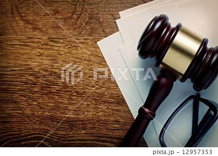 Wooden gavel and glasses on notepaper Wooden gavel and glasses on notepaper 12957353
