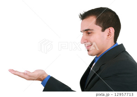 young adult male model  holds his hand flat, display or show som 12957713