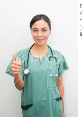 Asian female medical surgeon giving thumbs up sign Asian female medical surgeon giving thumbs up sign 12962149