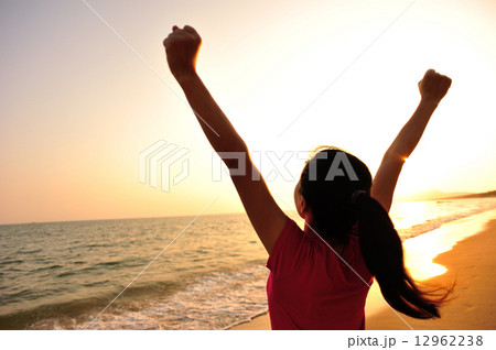 cheering woman open arms at sunset seaside beach cheering woman open arms at sunset seaside beach 12962238