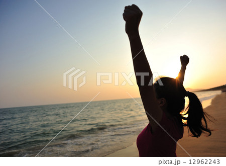 cheering woman open arms at sunset seaside beach cheering woman open arms at sunset seaside beach 12962243