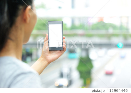 woman hands hold smart phone in modern city woman hands hold smart phone in modern city 12964446