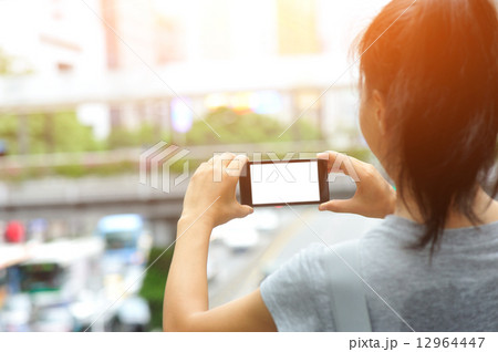 woman hands hold smart phone in modern city  12964447