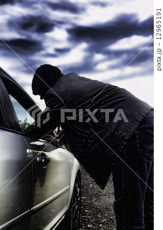 Hooligan breaking into car Hooligan breaking into car 12965191