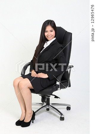 Woman in suit sitting with smile  12965476