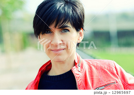 Woman with short hair wearing red jacket 12965697
