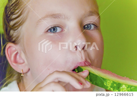 Cute girl eating watermelon Cute girl eating watermelon 12966615