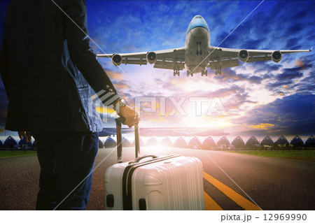 business man and luggage standing in airport and passenger jet p 12969990