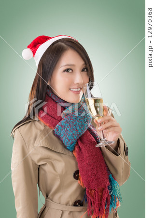 Smiling Asian woman hold a  glass of champagne 12970368