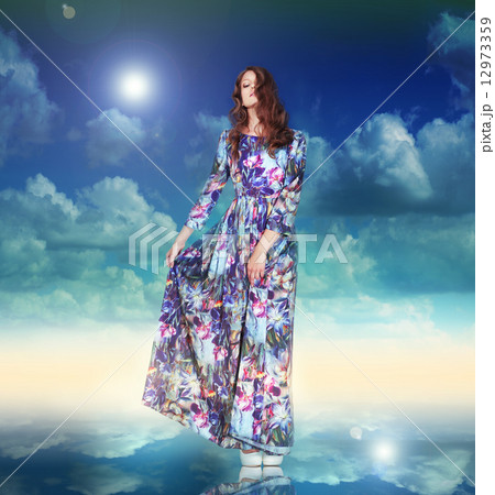 Imagination. Woman in Light Dress is Hovering among Clouds 12973359