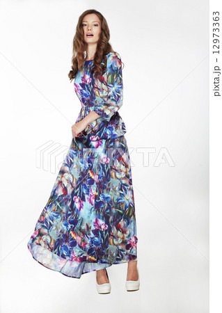 Elegant Fashionable Female in Silky Blue Flowery Dress 12973363