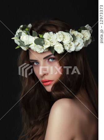 Luxurious Woman in Chaplet of Fresh Flowers 12973373