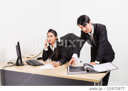 Two business people in serious discussion Two business people in serious discussion 12975877