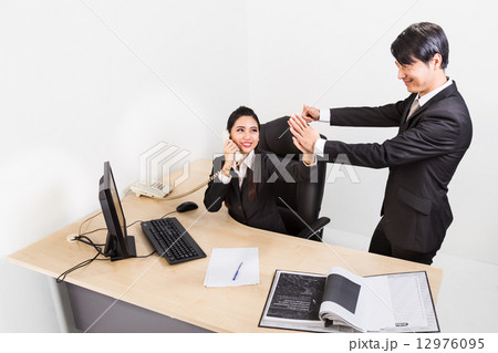 Two business person celebrate their success at the office with high five. 12976095