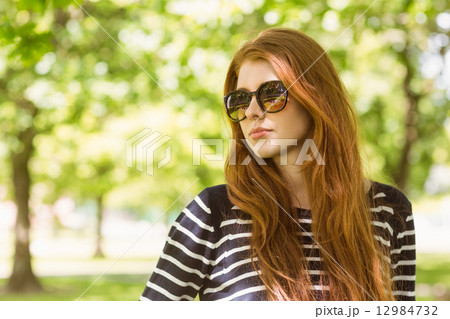 Beautiful woman looking away in park 12984732