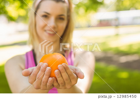 Fit blonde holding an orange Fit blonde holding an orange 12985450