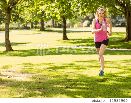 Fit blonde jogging in the park 12985966