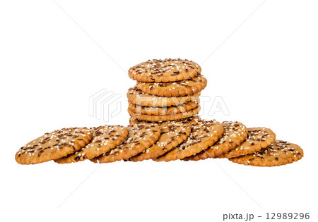 Stack and pile of round cookies with sesame and flax seeds Stack and pile of round cookies with sesame and flax seeds 12989296
