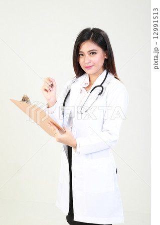 Female Doctor Holding Clipboard face forward 12991513