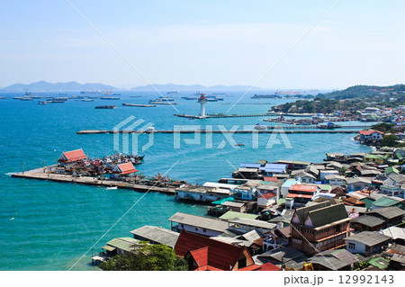 Aerial view of fisherman pier in with village and town at Sricha 12992143