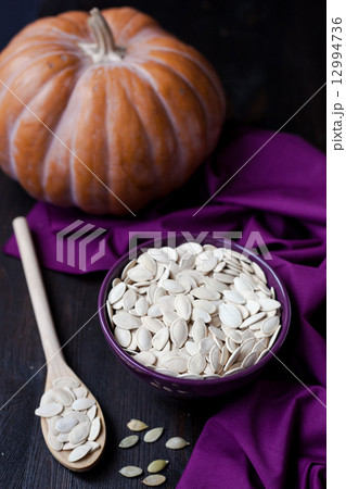 a bowl with toasted pumpkin seeds and wooden spoon a bowl with toasted pumpkin seeds and wooden spoon 12994736