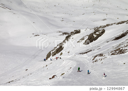 Snowboarders and skiers on ski slope at sun day 12994867