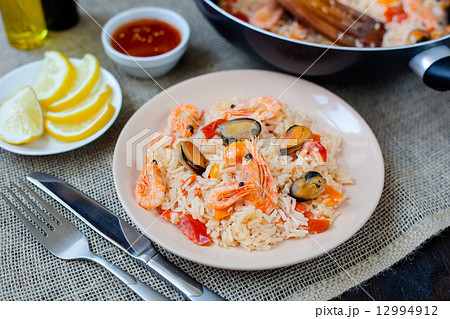 Spanish dish paella with seafood, shrimps in pan 12994912