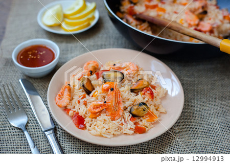 Spanish dish paella with seafood, shrimps in pan Spanish dish paella with seafood, shrimps in pan 12994913