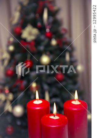 Decorated christmas tree with three candles Decorated christmas tree with three candles 12995422